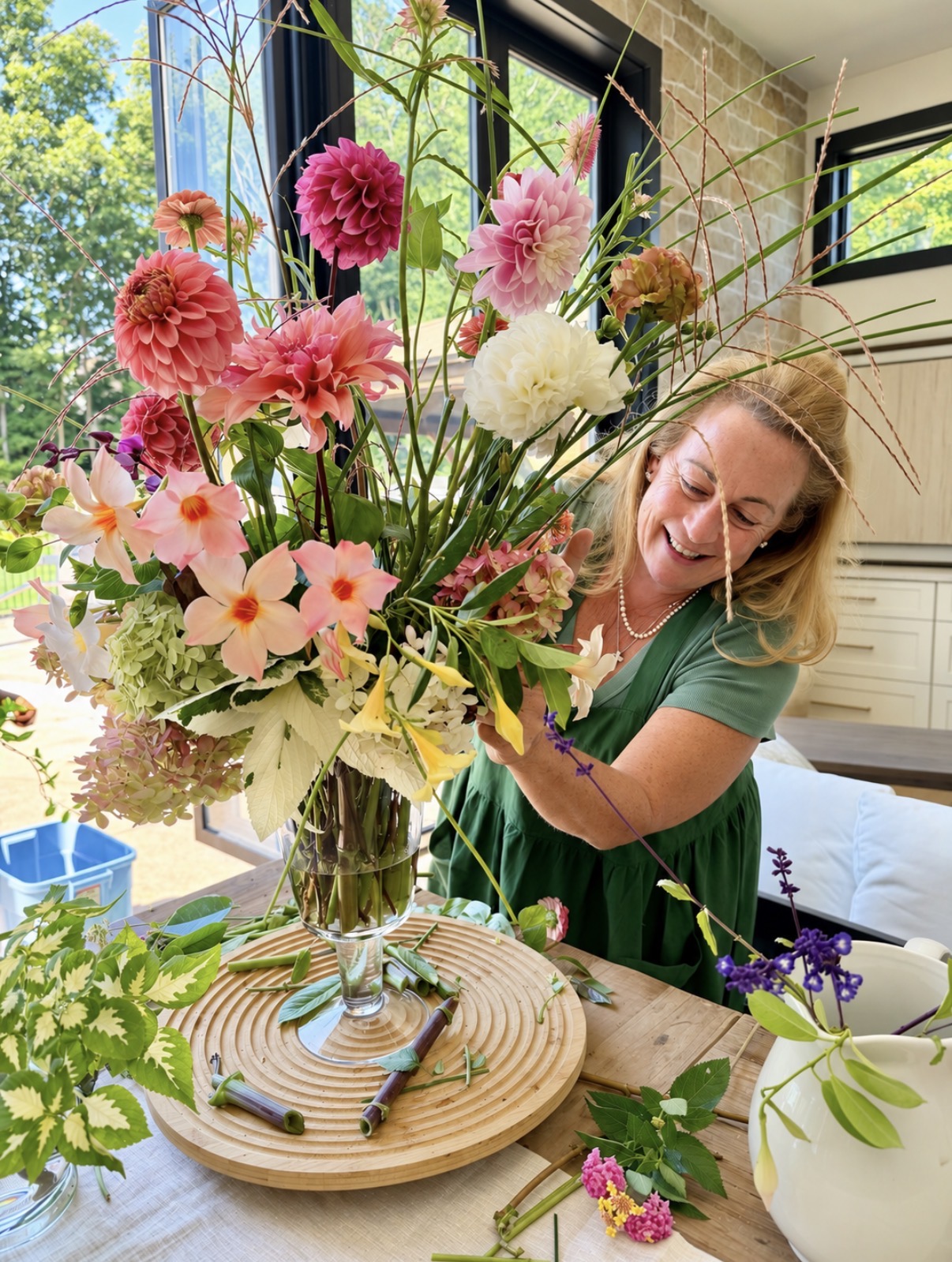 MaryAnn arranging colorful seasonal flowers at Bloom & Co.